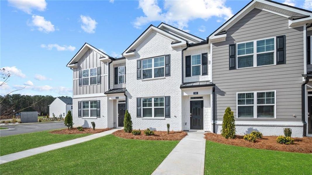 Front exterior of a new home in Echo Glen, Stockbridge, GA, highlighting curb appeal (Image 27). Front exterior of a new home in Echo Glen, Stockbridge, GA, highlighting curb appeal (Image 27).