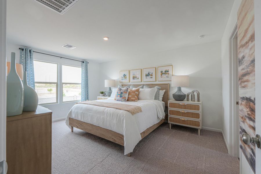 A bedroom with a bed and a window.