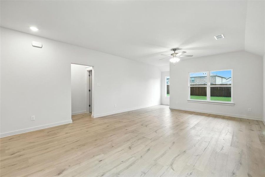 Unfurnished living room featuring a ceiling fan and light wood-style floors