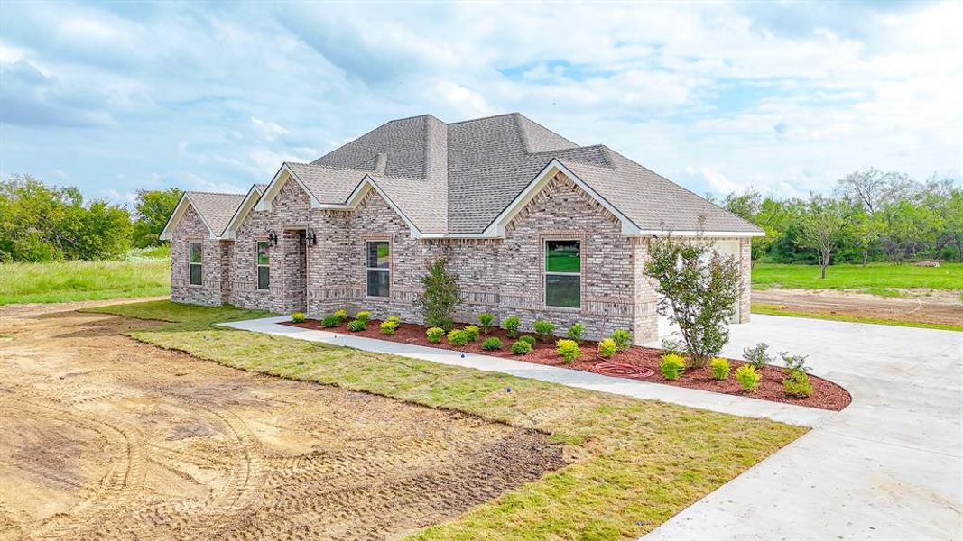 Front exterior of a new home in , Corsicana, TX, highlighting curb appeal (Image 21). Front exterior of a new home in , Corsicana, TX, highlighting curb appeal (Image 21).