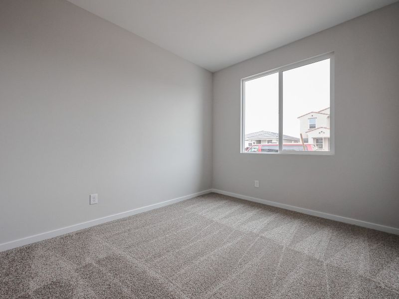 A room with a window and carpet.