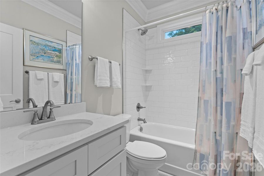Guest bathroom with beautifully tile shower.
