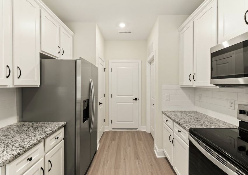 The kitchen has beautiful wood cabinetry
