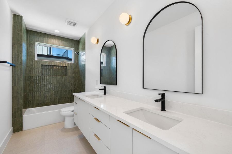 Bathroom featuring double vanity, shower / bath combination, light tile patterned flooring, and recessed lighting Bathroom featuring double vanity, shower / bath combination, light tile patterned flooring, and recessed lighting