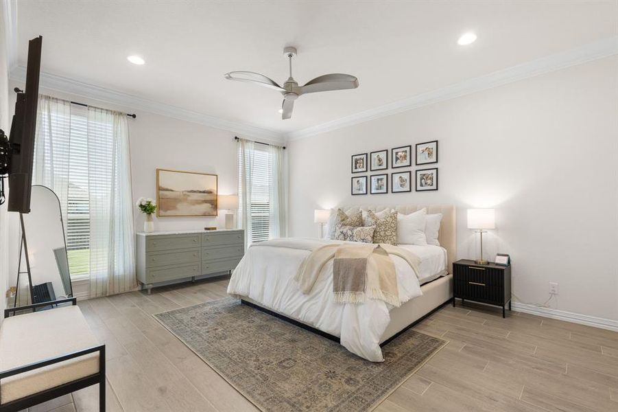 Bedroom with crown molding, light wood finished floors, ceiling fan, and recessed lighting Bedroom with crown molding, light wood finished floors, ceiling fan, and recessed lighting