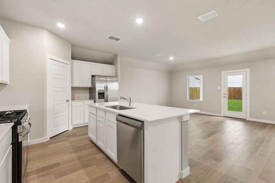 Kitchen in the Emmy II home plan by Trophy Signature Homes - REPRESENTATIVE PHOTO