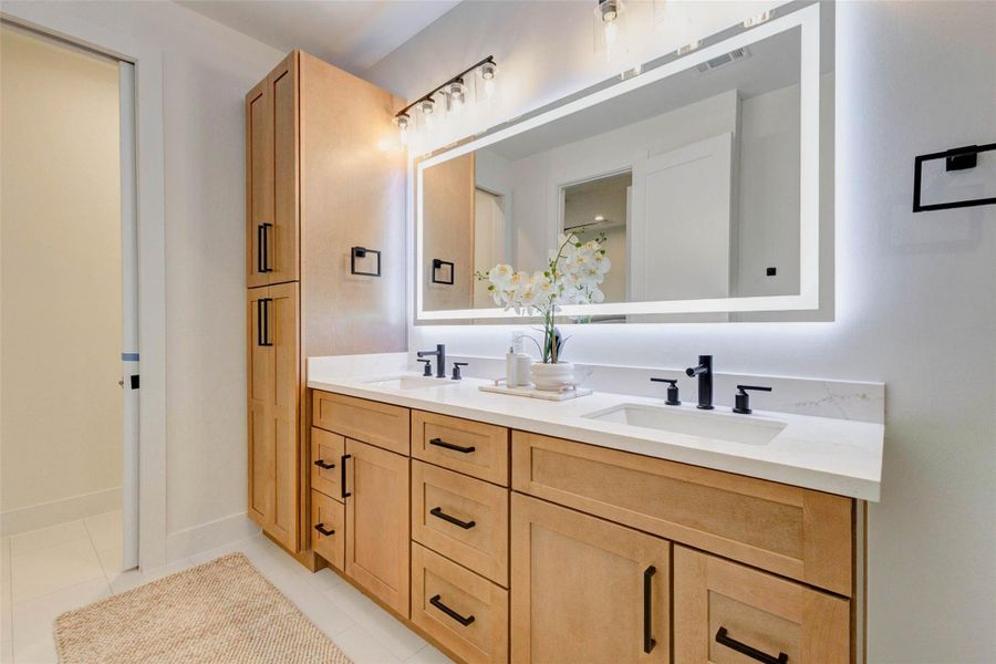 LED vanity mirrors with multicolor lighting and built-in defoggers. Space-saving pocket doors enhance functionality.