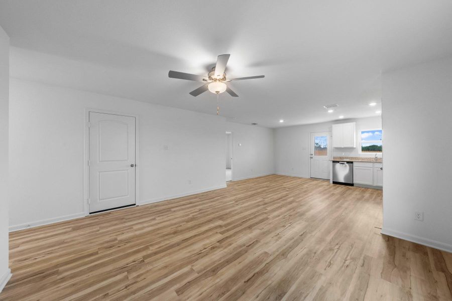 Unfurnished living room featuring light wood-style flooring, recessed lighting, and ceiling fan