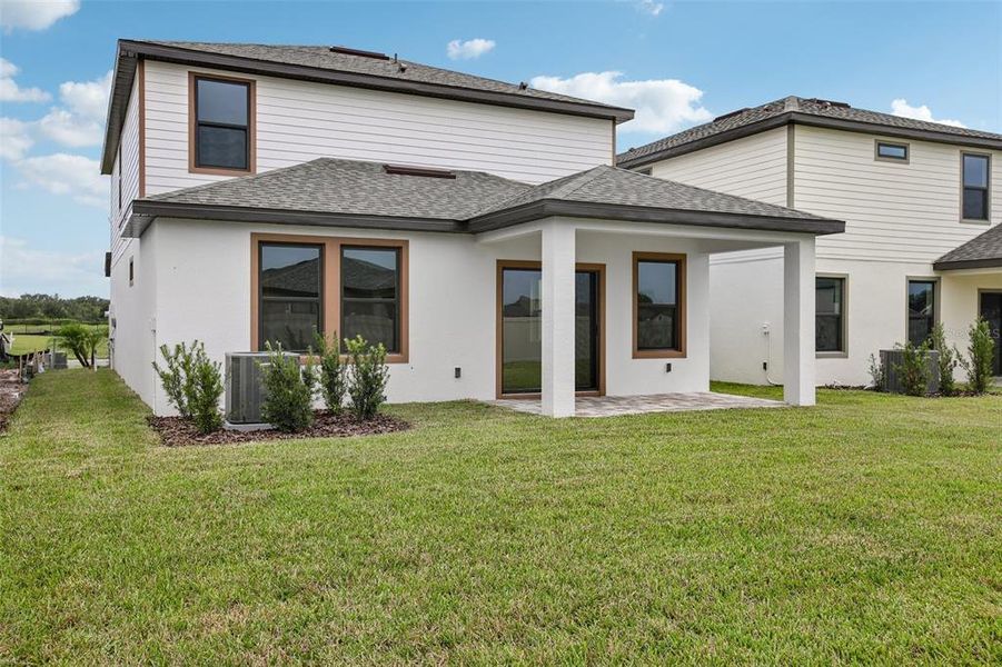 Exterior details and patio area of a home in Grasslands West, Lakeland (Image 26).