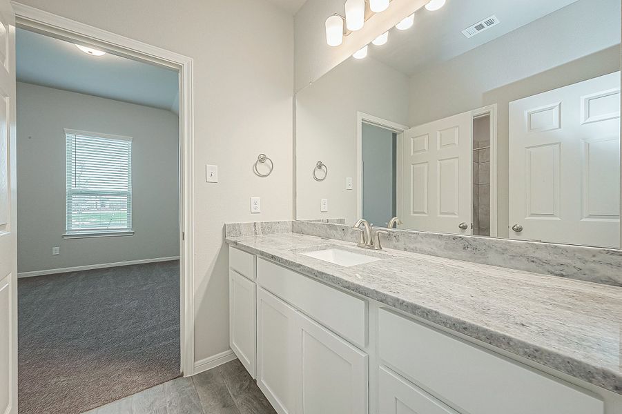 Representative furnished interior of a home built from the Floor Plan 2050 by Colina Homes in Grand Magnolia, Magnolia (Image 33).
