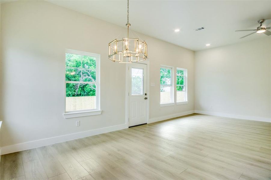 Foyer entrance featuring plenty of natural light, light wood-style flooring, and baseboards