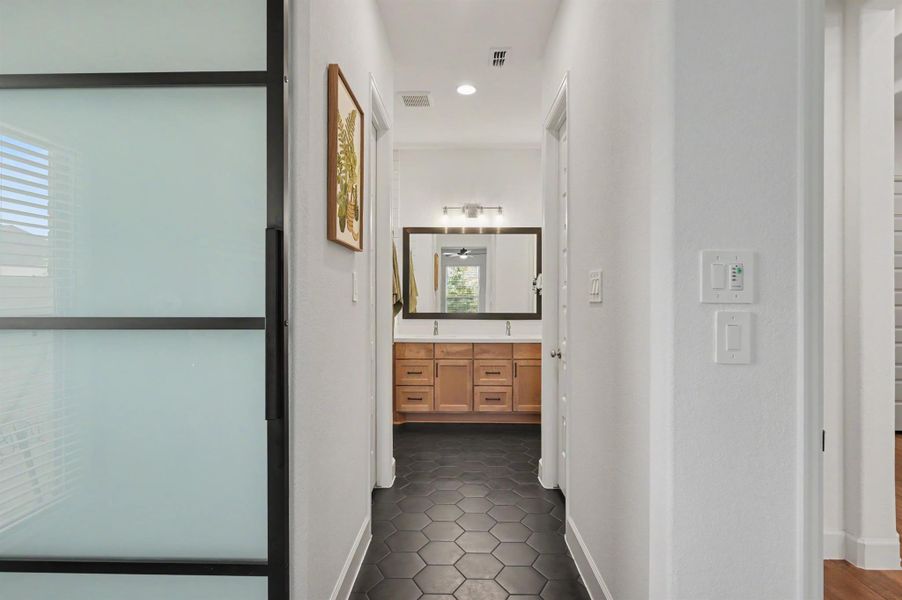 This bathroom has octagonal tile floors and a maple stained vanity. There are two closets on each side of the hallway. This bathroom has octagonal tile floors and a maple stained vanity. There are two closets on each side of the hallway.