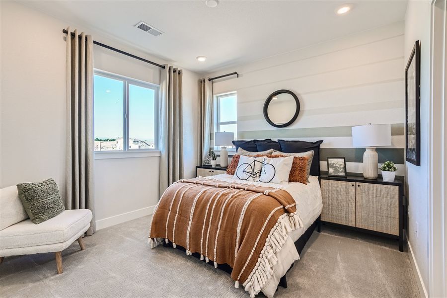 A bedroom with a bed and a chair. A bedroom with a bed and a chair.