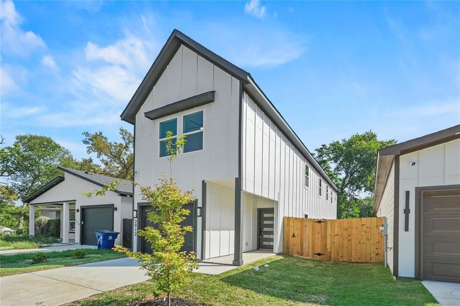 View of front of home with board and batten siding and a garage