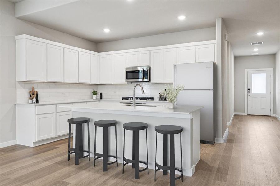 Kitchen in the Stanley II home plan by Trophy Signature Homes – REPRESENTATIVE PHOTO