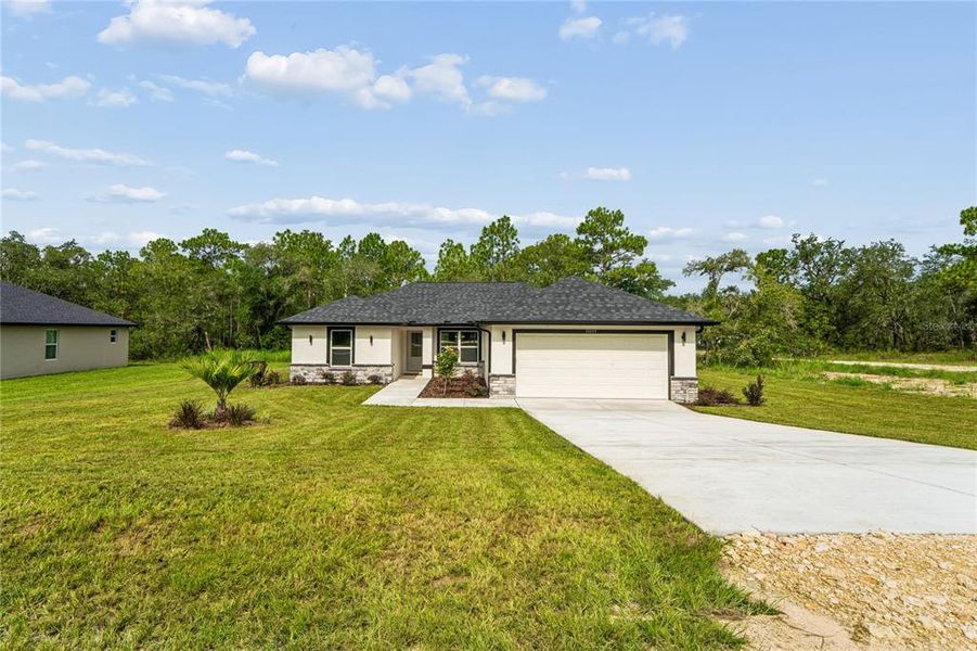 Front exterior of a new home in , Brooksville, FL, highlighting curb appeal (Image 27).