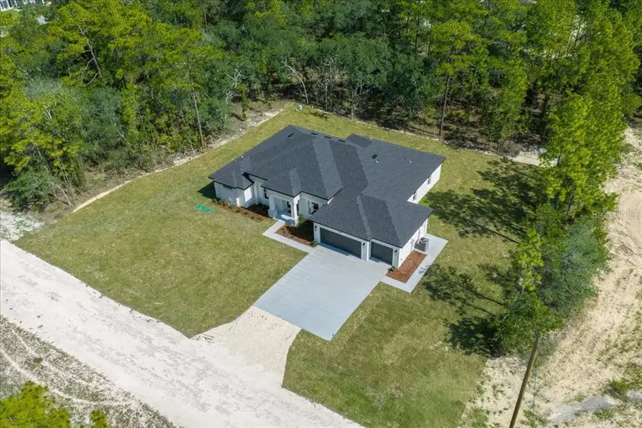 Front exterior of a new home in , Weeki Wachee, FL, highlighting curb appeal (Image 34). Front exterior of a new home in , Weeki Wachee, FL, highlighting curb appeal (Image 34).
