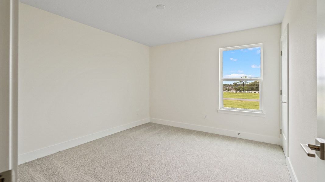 The Sweetgum Spacious and Bright Third bedroom upstairs in Trailside at Mount Dora by DRB Homes