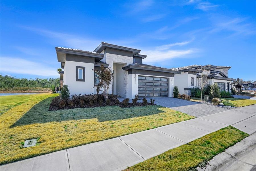 Front exterior of a new home in Hampton Green at Providence, Davenport, FL, highlighting curb appeal (Image 21).