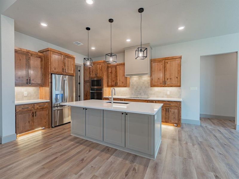 Kitchen with tons of cabinet storage and counter prep work space with an island for the party spread
