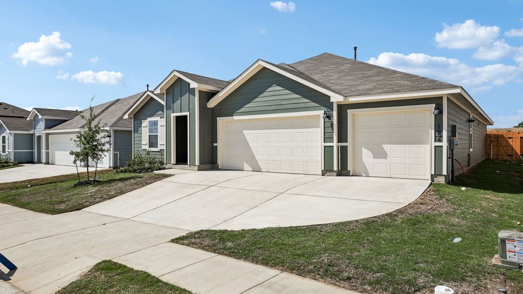 Front exterior of a new home in Prairie Lakes, Buda, TX, highlighting curb appeal (Image 21).