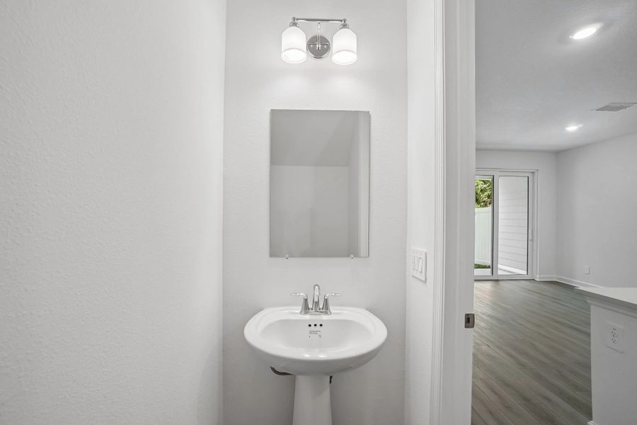 Half bathroom located just off the kitchen on the first floor