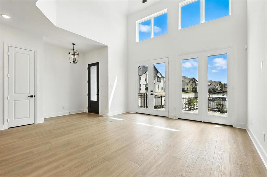 Entryway featuring a high ceiling and light wood-style flooring Entryway featuring a high ceiling and light wood-style flooring