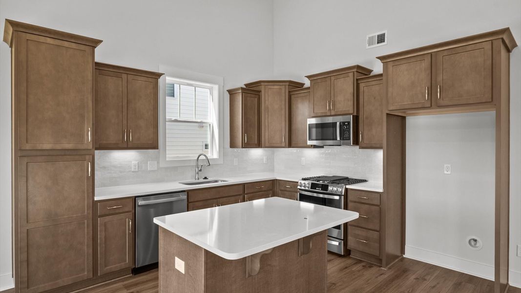 Modern kitchen with streamlined island for easy prep, storage, and gathering