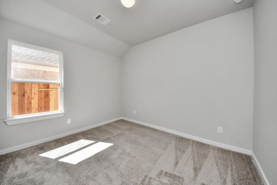 Secondary bedroom features plush carpeting, large windows that let in plenty of natural light, bright paint, and spacious closets. Sample photo of completed home with similar floor plan. Actual colors and selections may vary. Secondary bedroom features plush carpeting, large windows that let in plenty of natural light, bright paint, and spacious closets. Sample photo of completed home with similar floor plan. Actual colors and selections may vary.