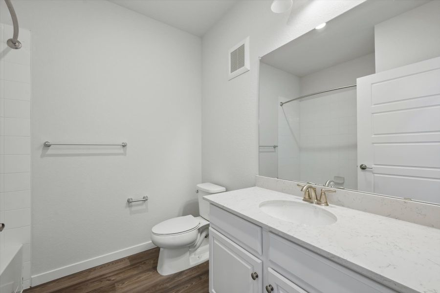 A bathroom with a sink toilet and shower.