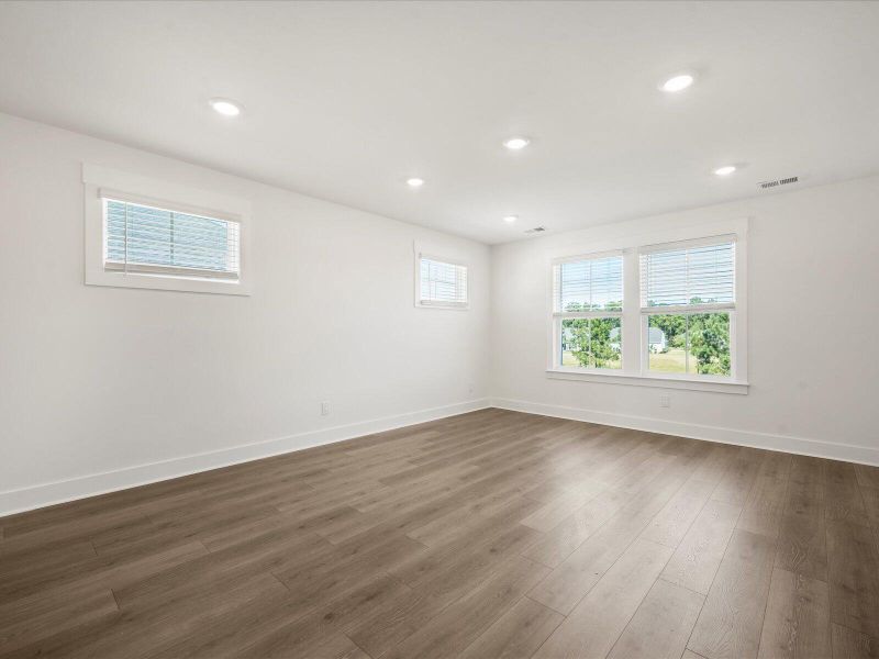 Spacious, unfurnished interior of a new home in The Coves at Lakes of Cane Bay, Summerville (Image 22).