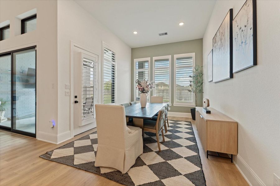 The open dining area is filled with natural light and offers the perfect setting for intimate dinners or large gatherings alike.