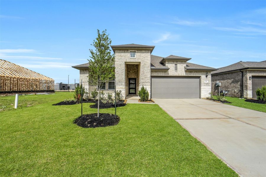 Front exterior of a new home in Windmill Estates, Magnolia, TX, highlighting curb appeal (Image 29).