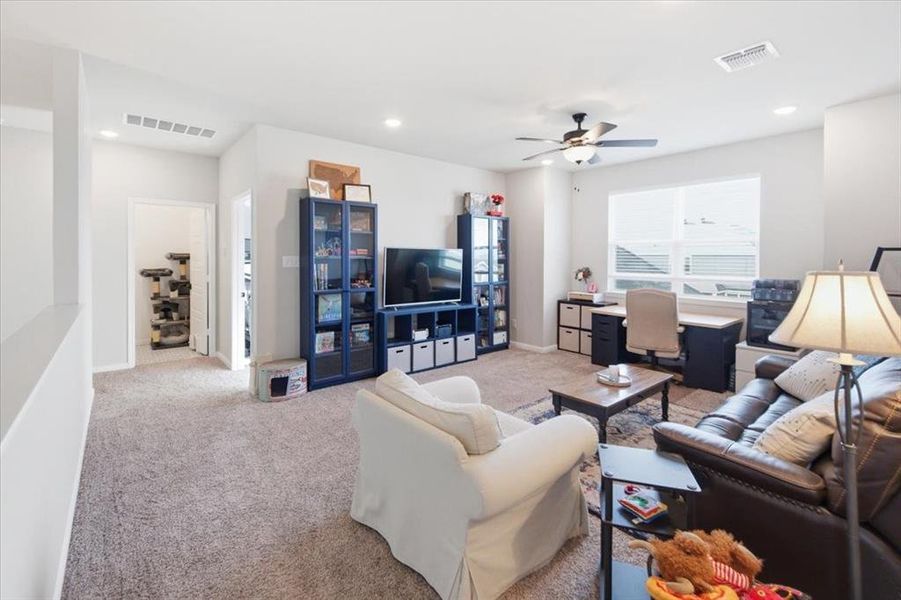 Carpeted 2nd living area with a ceiling fan and with recessed and natural lighting Carpeted 2nd living area with a ceiling fan and with recessed and natural lighting