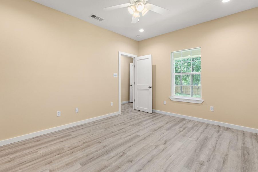 Spare room with ceiling fan, light wood-style floors, and recessed lighting