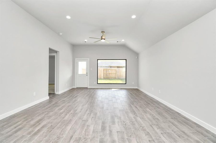 Discover another view of this beautiful family room with a large picture window that allows scenic views. Sample photo of completed home with similar floor plan. Actual colors and selections may vary.