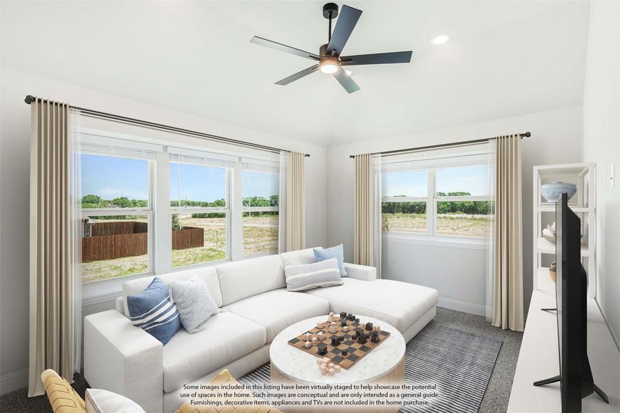 Living room with white sectional sofa, ceiling fan, and large windows with outdoor views