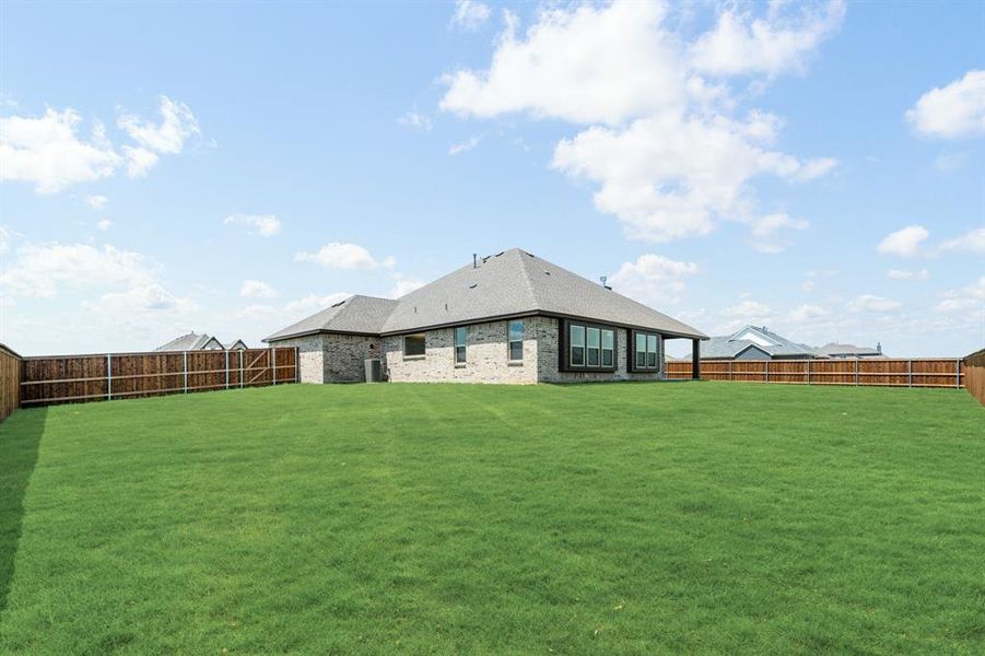 Front exterior of a new home in Wildcat Ridge Phase 2 and 4, Godley, TX, highlighting curb appeal (Image 26). Front exterior of a new home in Wildcat Ridge Phase 2 and 4, Godley, TX, highlighting curb appeal (Image 26).