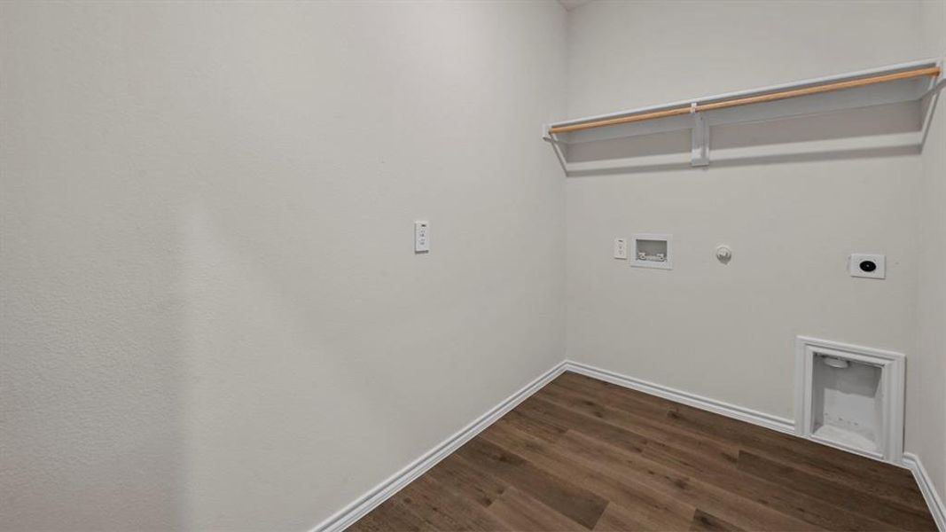 Laundry room featuring hookup for a gas dryer, dark wood-style flooring, electric dryer hookup, and hookup for a washing machine