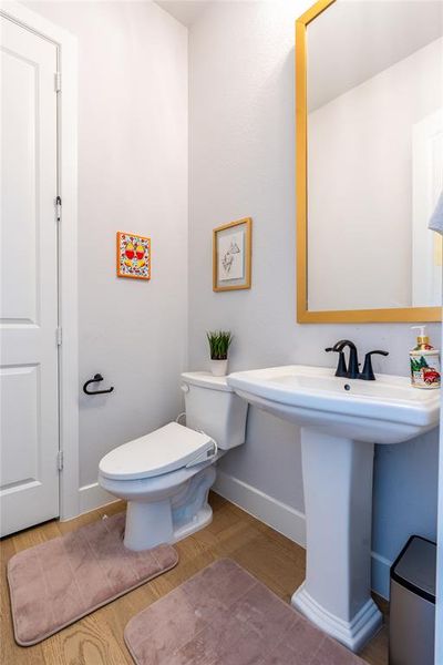 Bathroom featuring light wood finished floors and baseboards