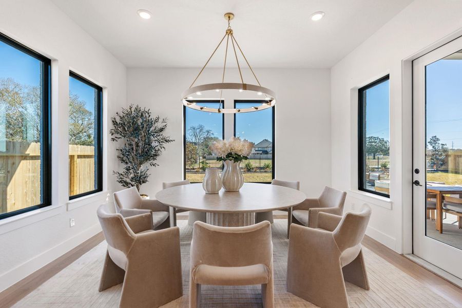 A statement chandelier anchors the space, while refined finishes and seamless access to the outdoor patio create an inviting setting for intimate dinners and sophisticated entertaining A statement chandelier anchors the space, while refined finishes and seamless access to the outdoor patio create an inviting setting for intimate dinners and sophisticated entertaining