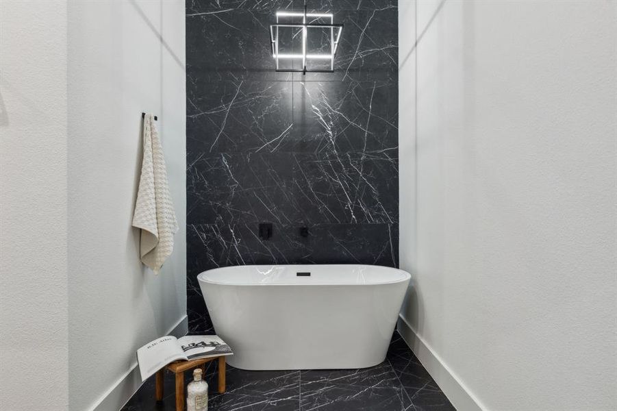 Bathroom featuring tile walls and a bathing tub