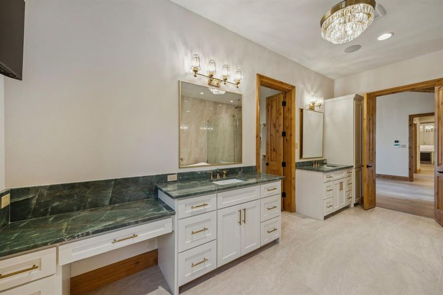 Full bath with two vanities, a shower stall, and recessed lighting