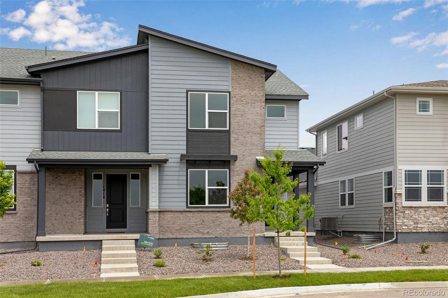 Front exterior of a new home in Sugar Mill Village, Longmont, CO, highlighting curb appeal (Image 2). Front exterior of a new home in Sugar Mill Village, Longmont, CO, highlighting curb appeal (Image 2).