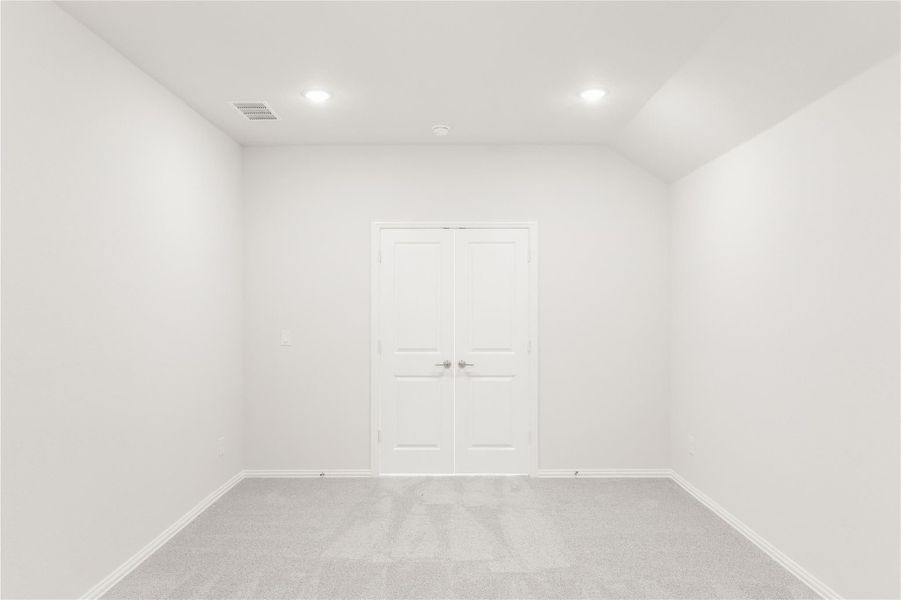 Empty room with white walls, carpet flooring, recessed lighting, and double doors Empty room with white walls, carpet flooring, recessed lighting, and double doors