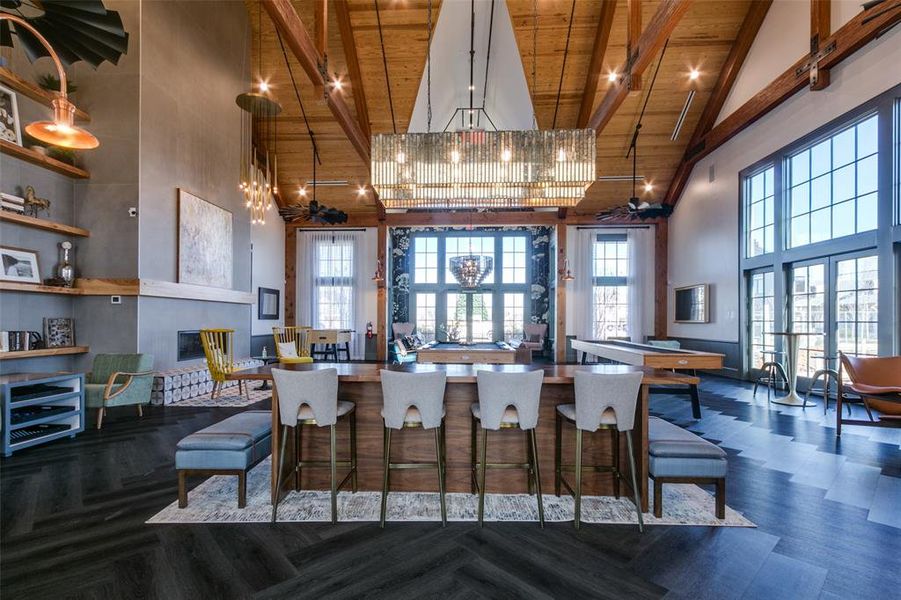 Kitchen with a notable chandelier, beam ceiling, wood ceiling, and high vaulted ceiling