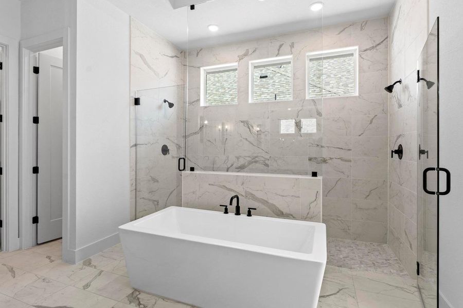Bathroom featuring a marble finish shower, a soaking tub, light marble finish flooring, and recessed lighting Bathroom featuring a marble finish shower, a soaking tub, light marble finish flooring, and recessed lighting