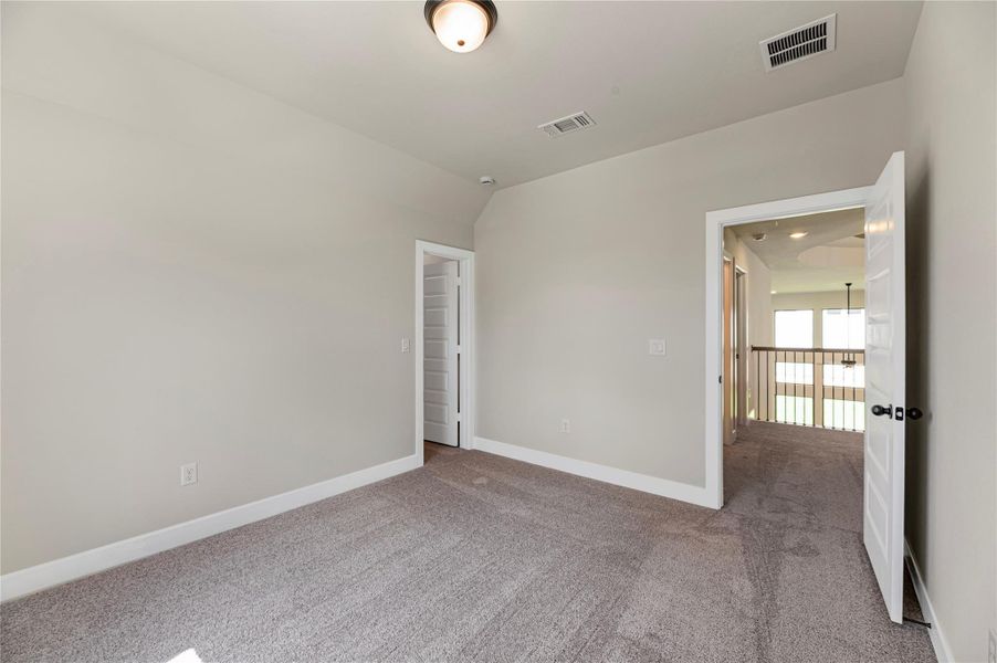 Unfurnished room featuring carpet floors and vaulted ceiling