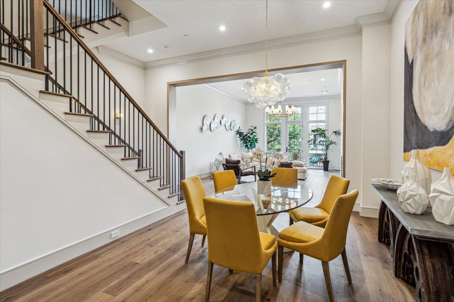 The dining room separates the family room from the kitchen. The open nature of the room means whatever size table you have, it will integrate perfectly. The whimsical Talia chandelier consists of swirled, artisanal glass orbs suspended on a metal frame, creating a dynamic and sculptural light fixture--the perfect focal point for your dining room. The dining room separates the family room from the kitchen. The open nature of the room means whatever size table you have, it will integrate perfectly. The whimsical Talia chandelier consists of swirled, artisanal glass orbs suspended on a metal frame, creating a dynamic and sculptural light fixture--the perfect focal point for your dining room.