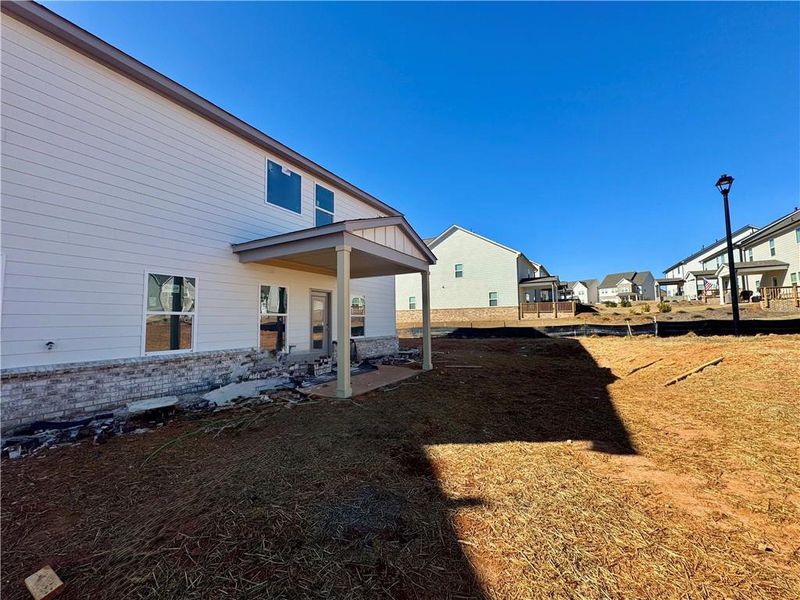 Exterior details and patio area of a home in Eastlyn Crossing - Single Family, Flowery Branch (Image 4).